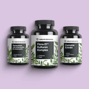 Drei Nahrungsergänzungsflaschen des Belly Balance Bundle mit der Aufschrift „NATURAL ELEMENTS“ in den Geschmacksrichtungen Mariendistel, Flora-21 Kulturen Komplex und Curcuma-Extrakt auf violettem Hintergrund.